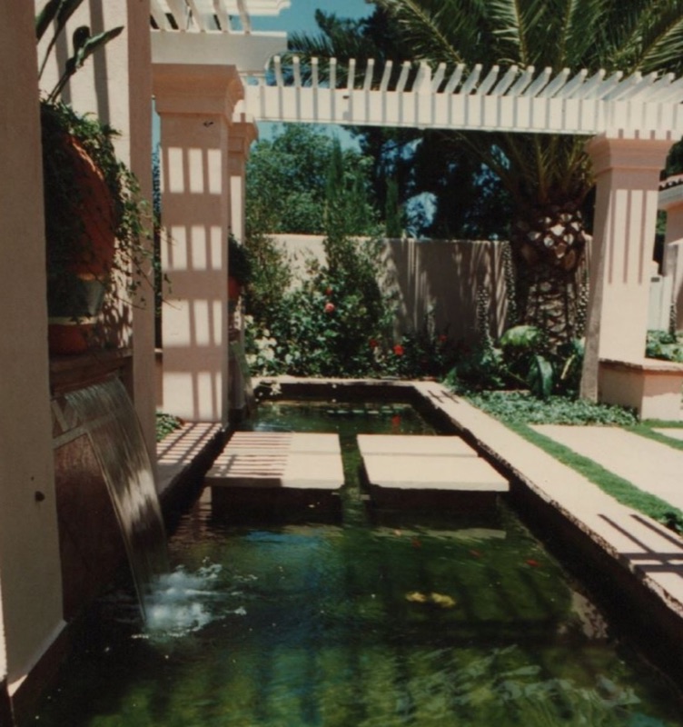 Koi pond with a sheer cascade, stepping-stone pads, and an arbor overhead — Campbell, CA