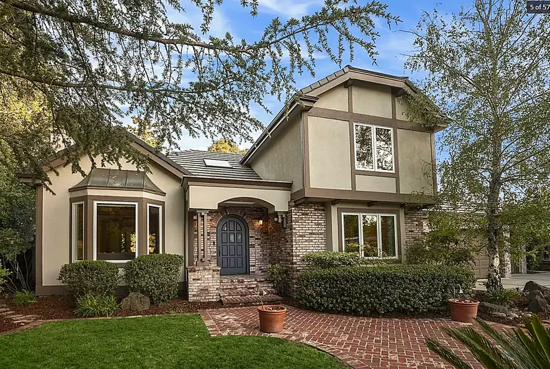 Craftsman home with stone entry, manicured plantings, and mature trees — Saratoga, CA
