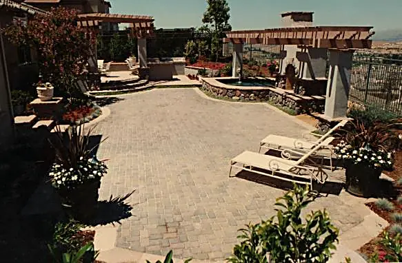 Hilltop paver terrace with spa, BBQ center, and eyebrow arbors overlooking the valley — Silver Creek, CA