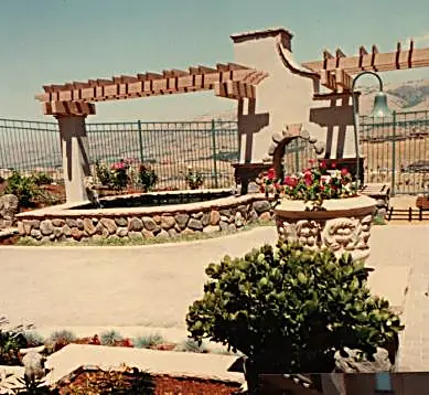See-through fireplace with stone surround, spa, and eyebrow arbor — Silver Creek, CA